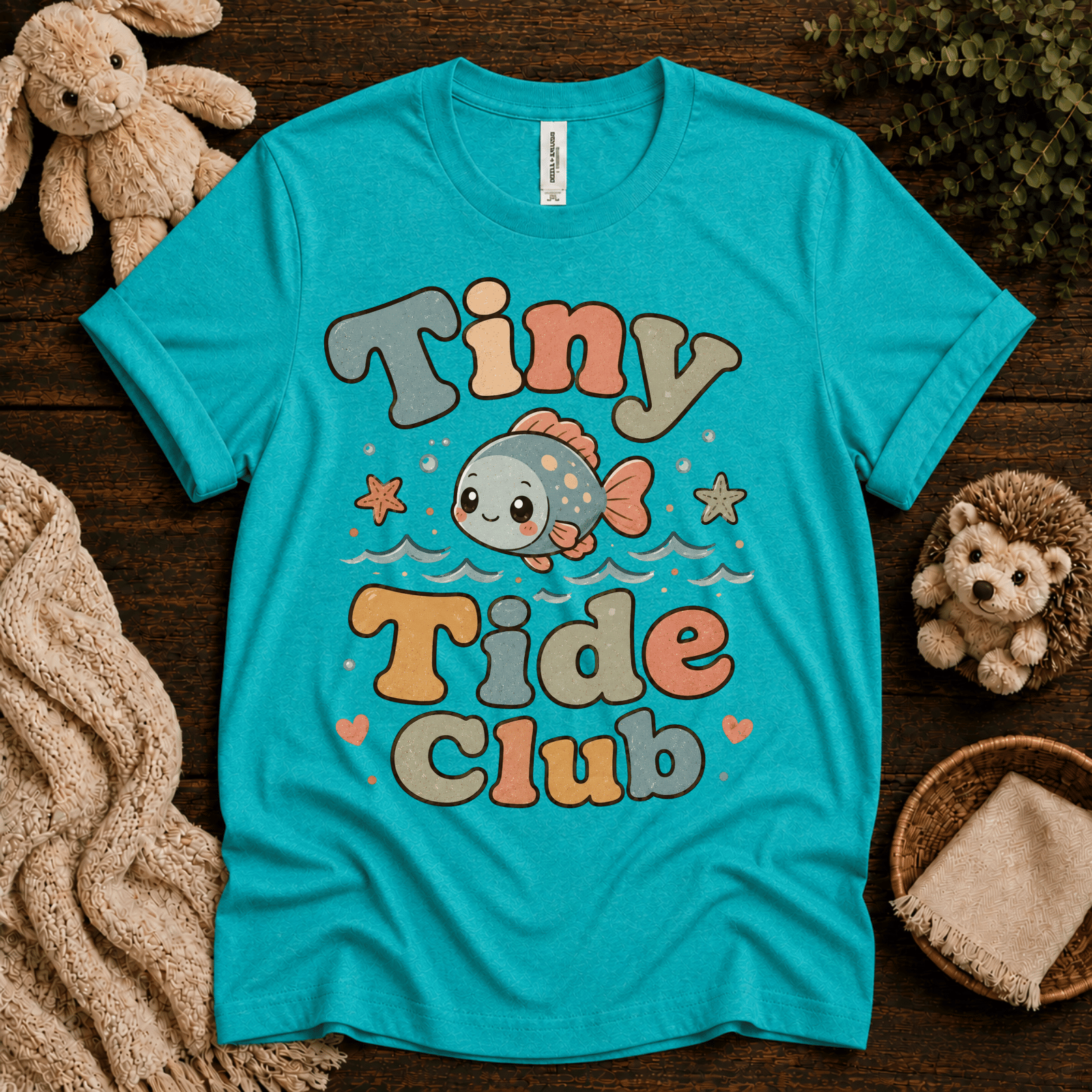 Tiny Tide Club cute animal graphic t-shirt cozy flat lay in heather sea green.