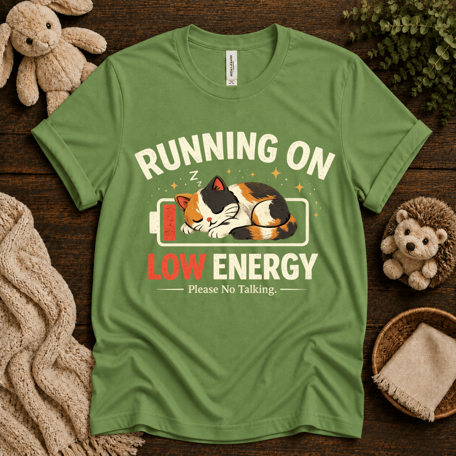 Low Energy Cat cute animal graphic t-shirt cozy flat lay in leaf.