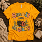 Small But Mighty cute animal graphic t-shirt cozy flat lay in gold.