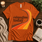 Reimagine Today inspirational introvert graphic t-shirt cozy flat lay in burnt orange.