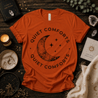 Quiet Comfort black print celestial  graphic t-shirt cozy flat lay in burnt orange.