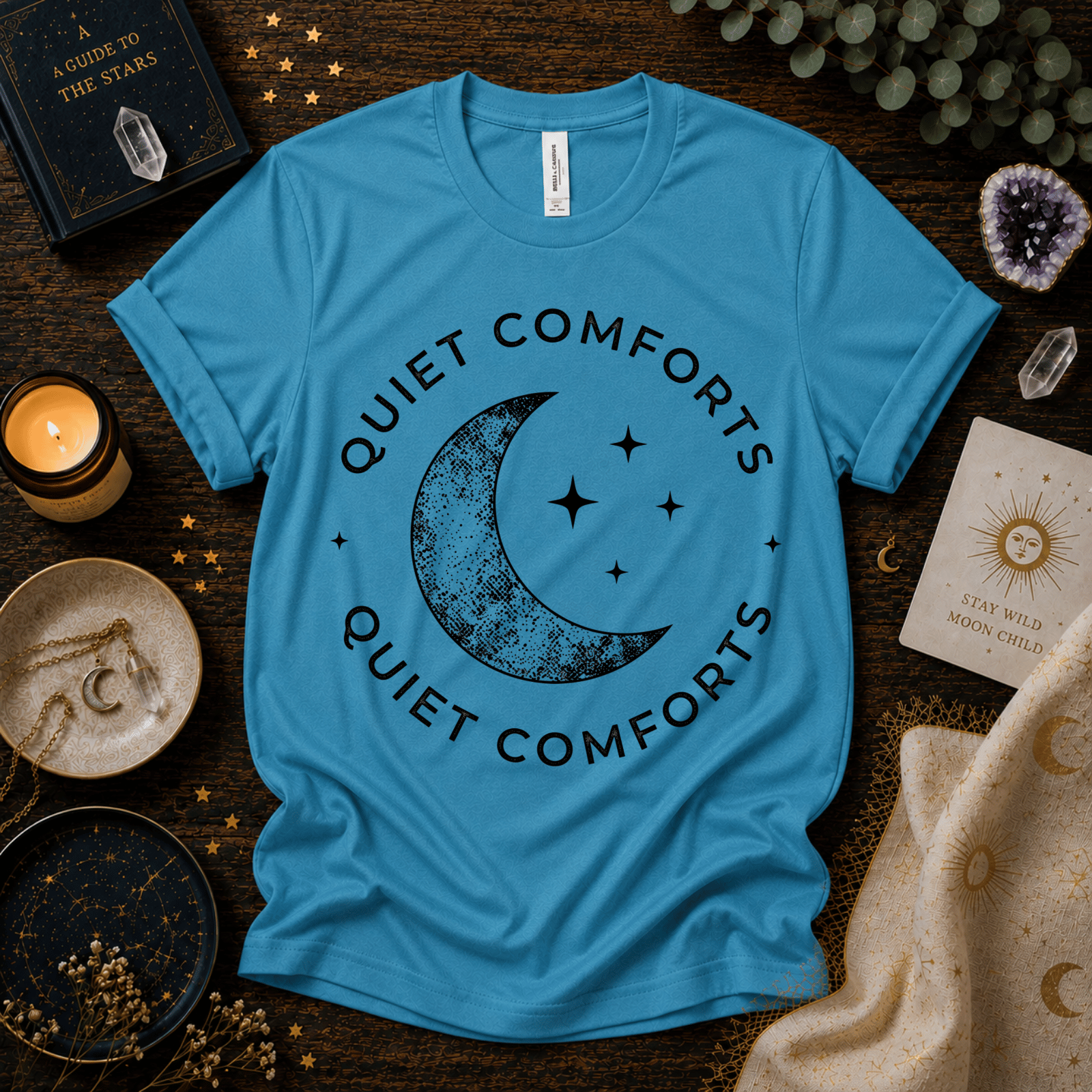Quiet Comfort black print celestial  graphic t-shirt cozy flat lay in aqua.