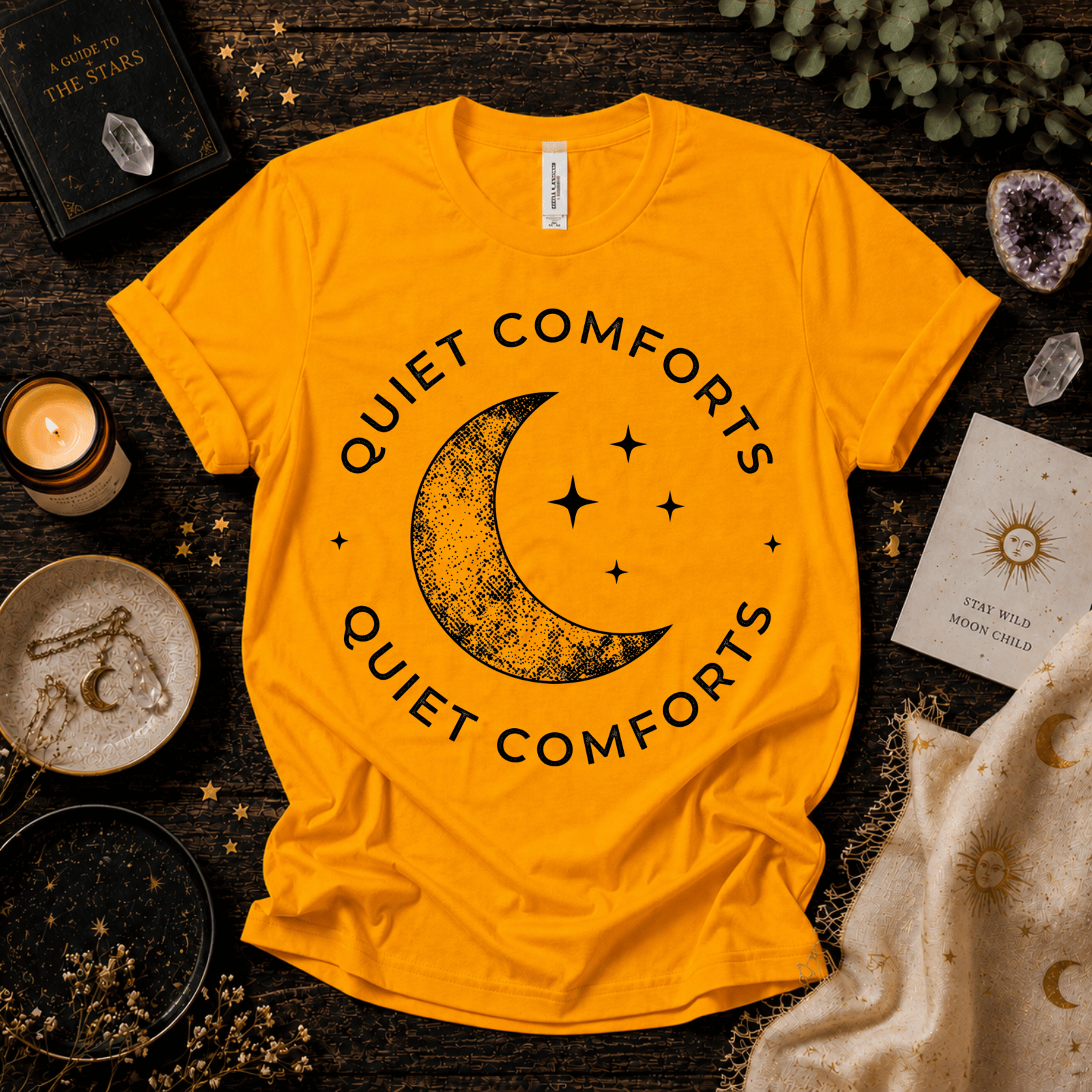 Quiet Comfort black print celestial  graphic t-shirt cozy flat lay in gold.