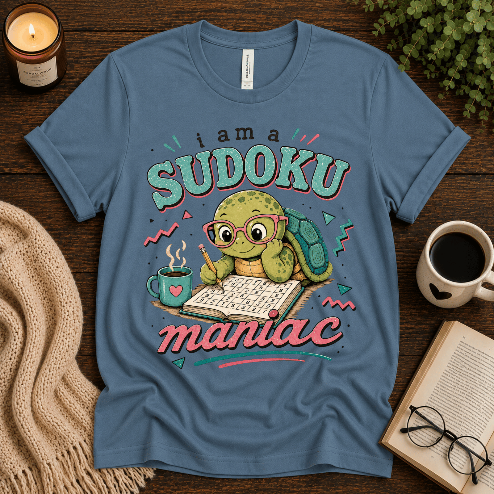 Sudoku Maniac funny introvert graphic t-shirt cozy flat lay in steel blue.