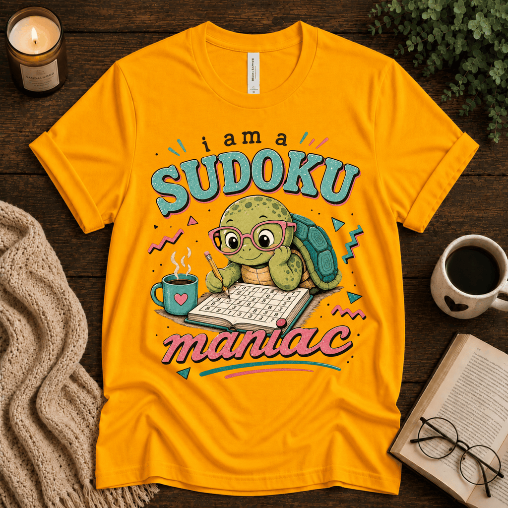 Sudoku Maniac funny introvert graphic t-shirt cozy flat lay in gold.