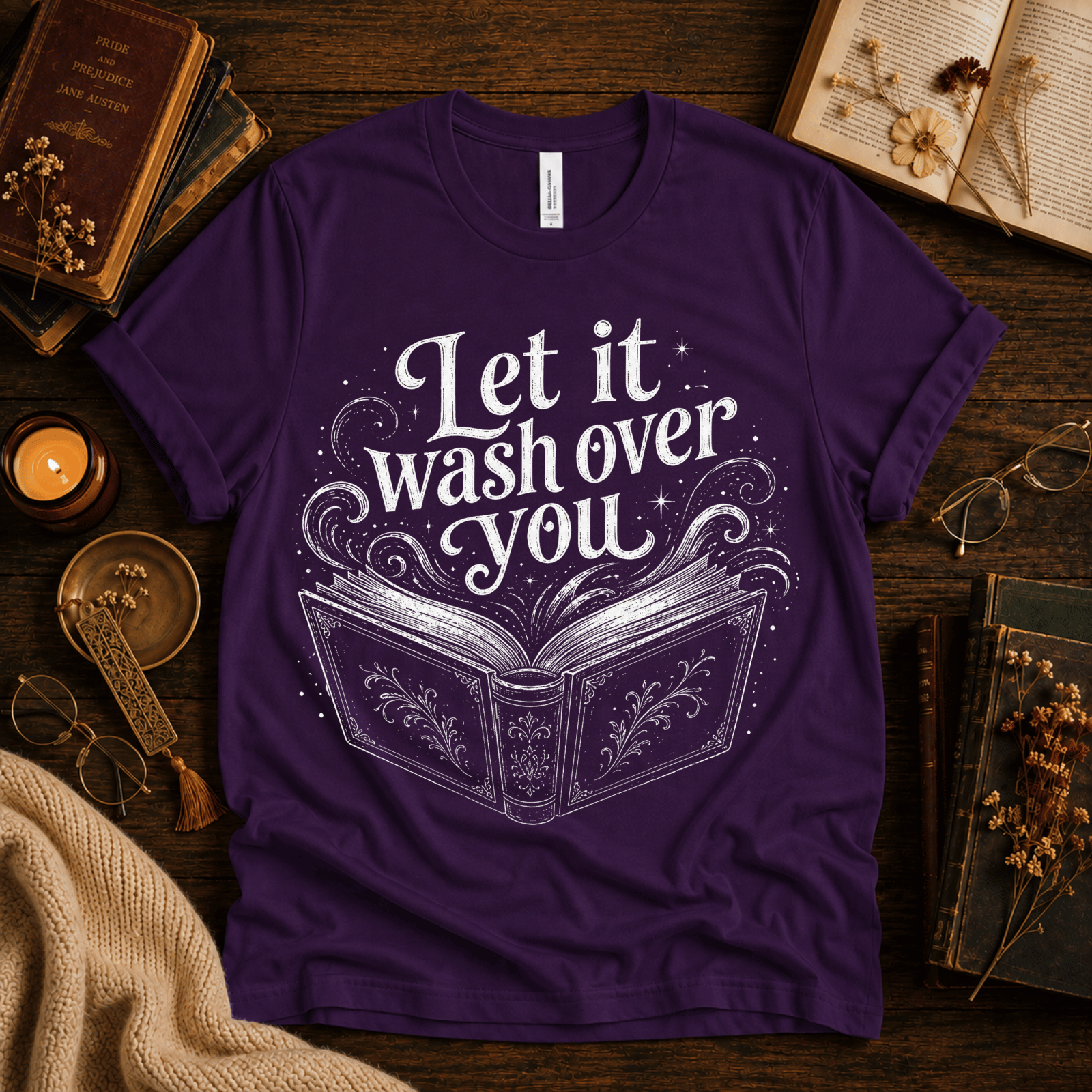 Let It Wash Over You whimsical book graphic t-shirt cozy flat lay in team purple.