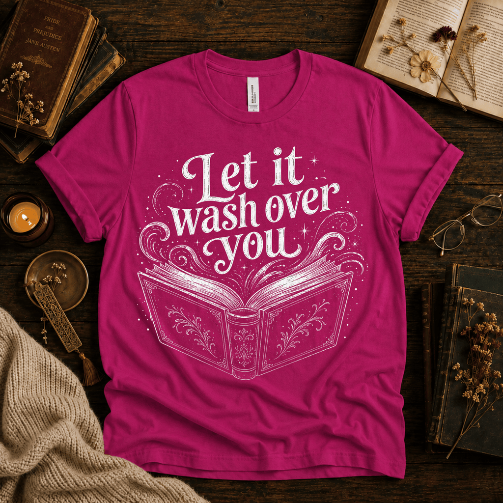 Let It Wash Over You whimsical book graphic t-shirt cozy flat lay in charity pink.