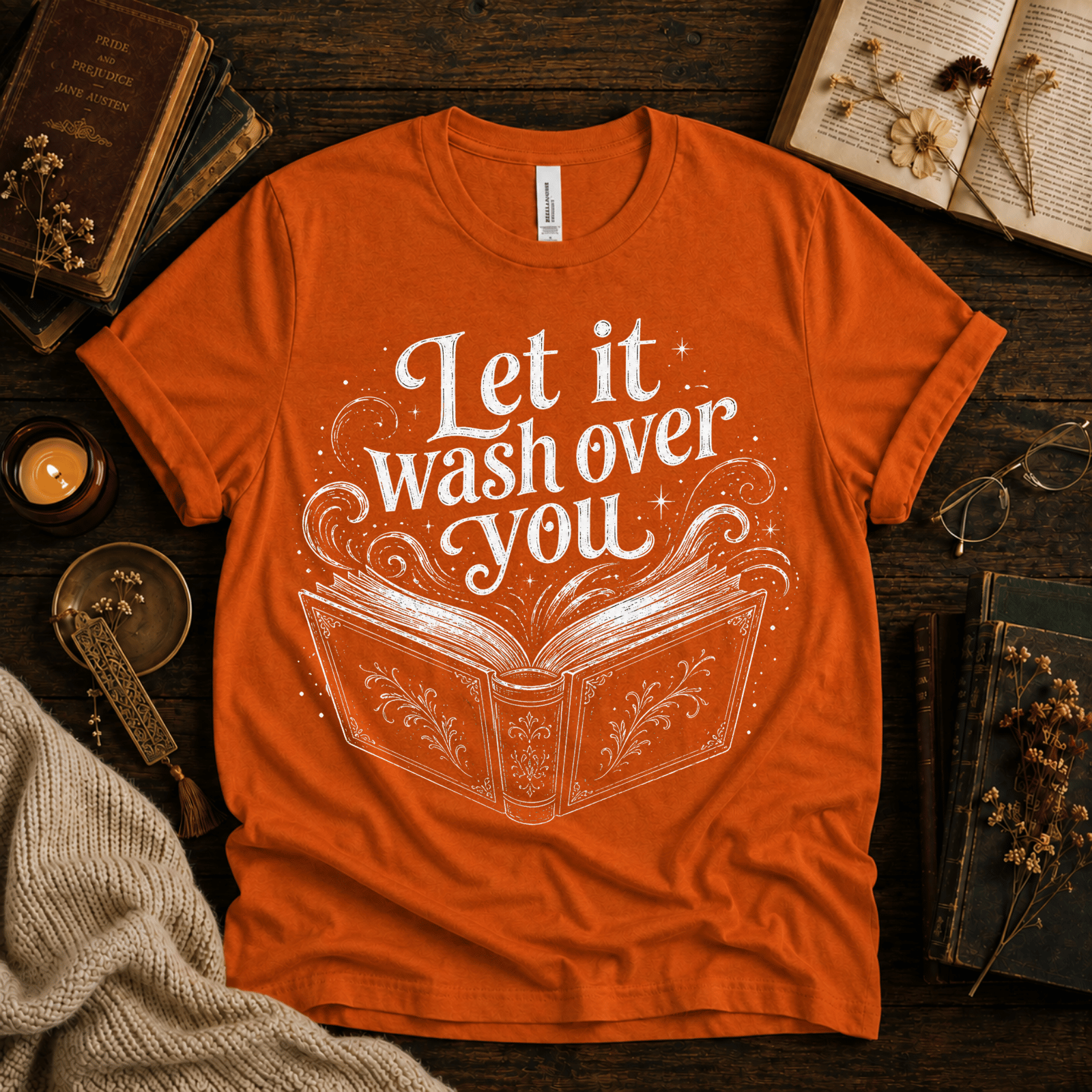 Let It Wash Over You whimsical book graphic t-shirt cozy flat lay in burnt orange.