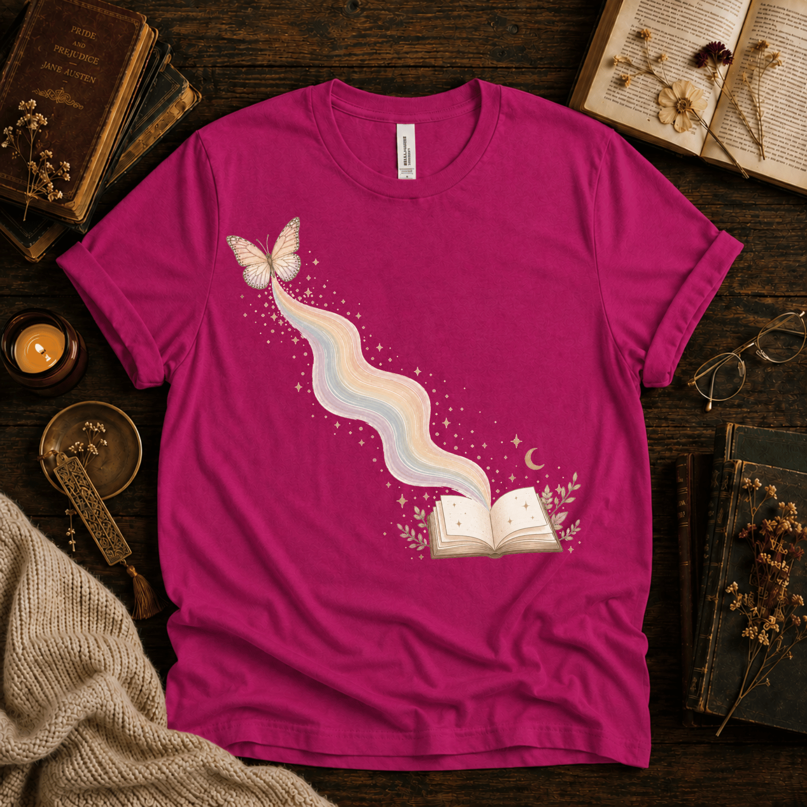 Rainbow Book whimsical book graphic t-shirt cozy flat lay in charity pink.