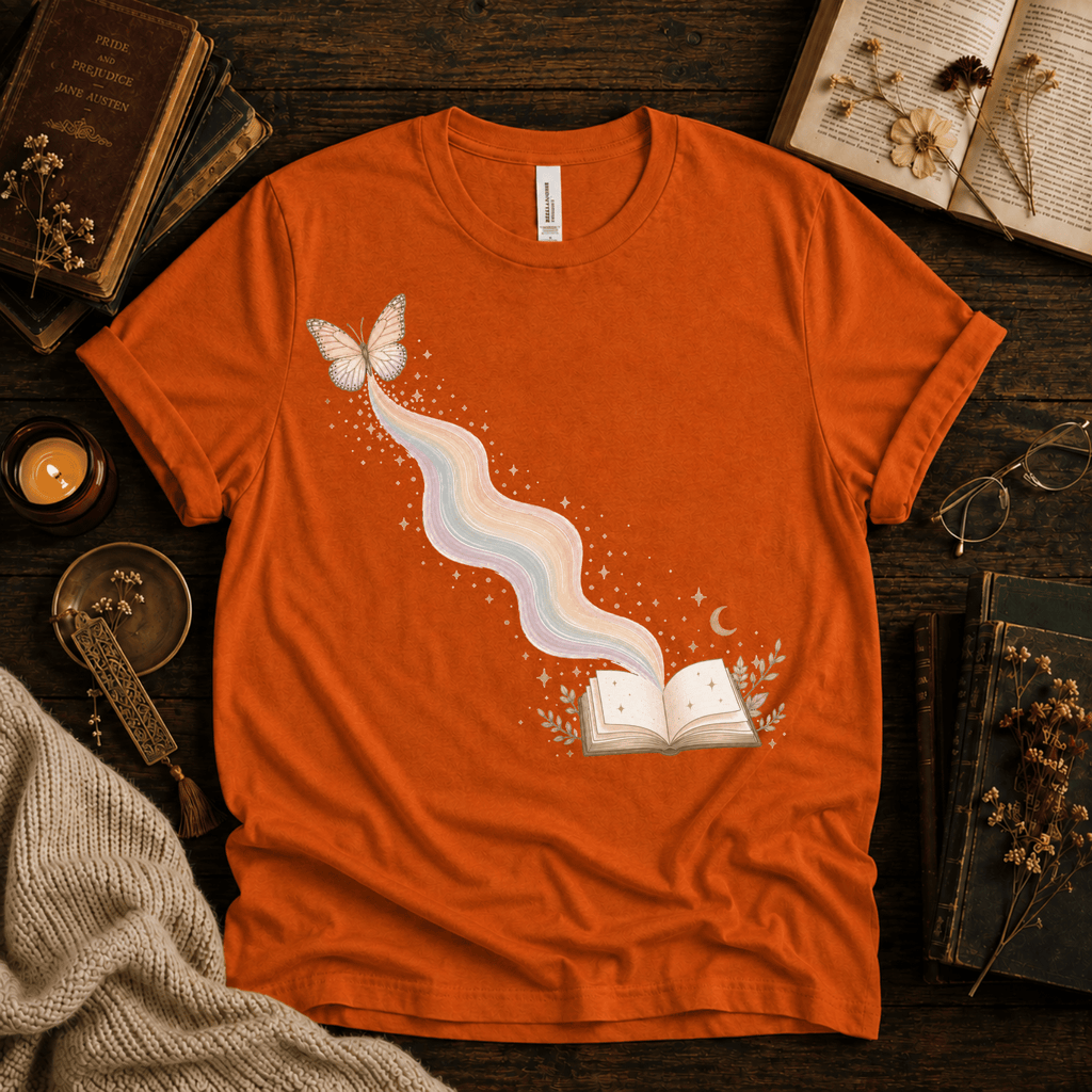 Rainbow Book whimsical book graphic t-shirt cozy flat lay in burnt orange.