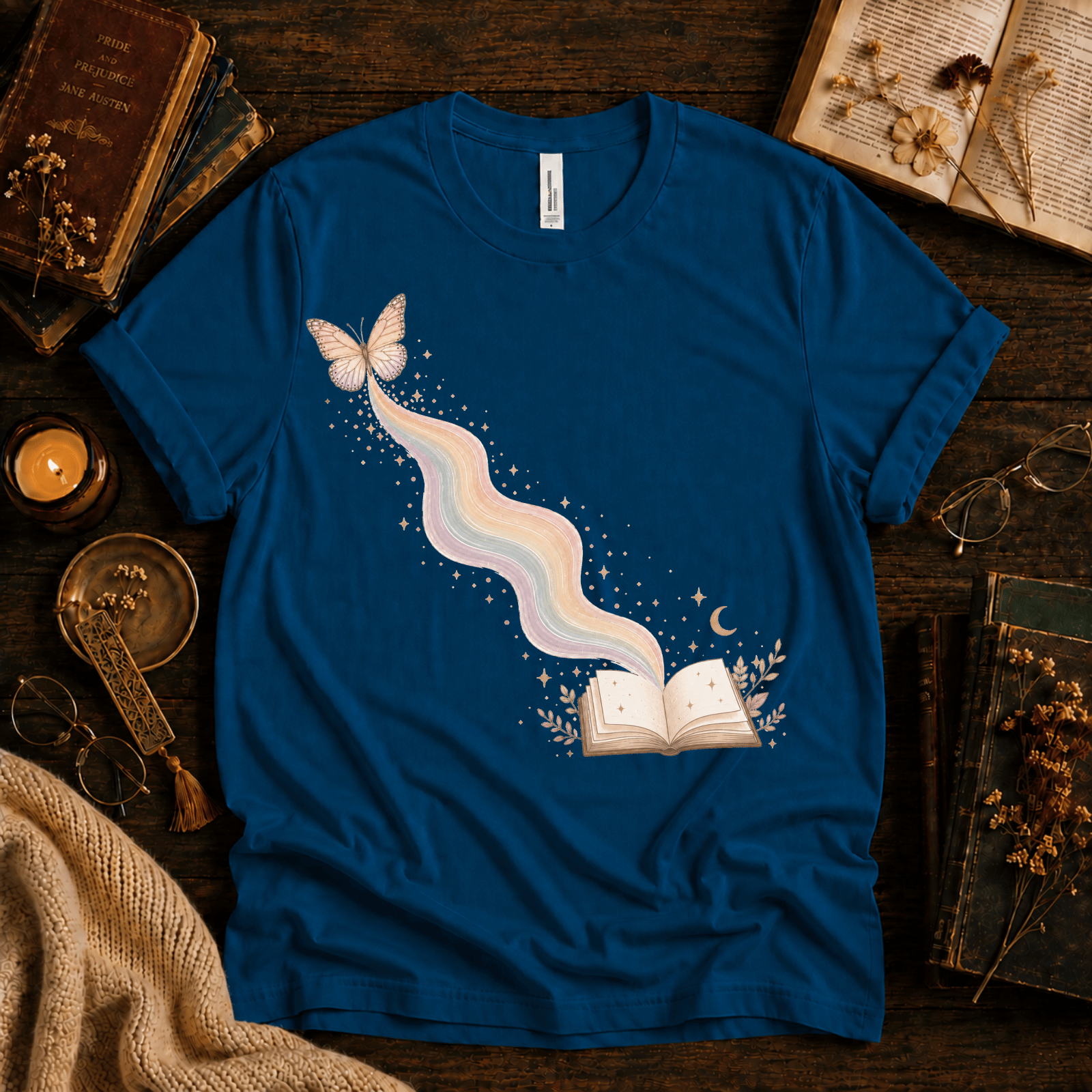 Rainbow Book whimsical book graphic t-shirt cozy flat lay in deep teal.