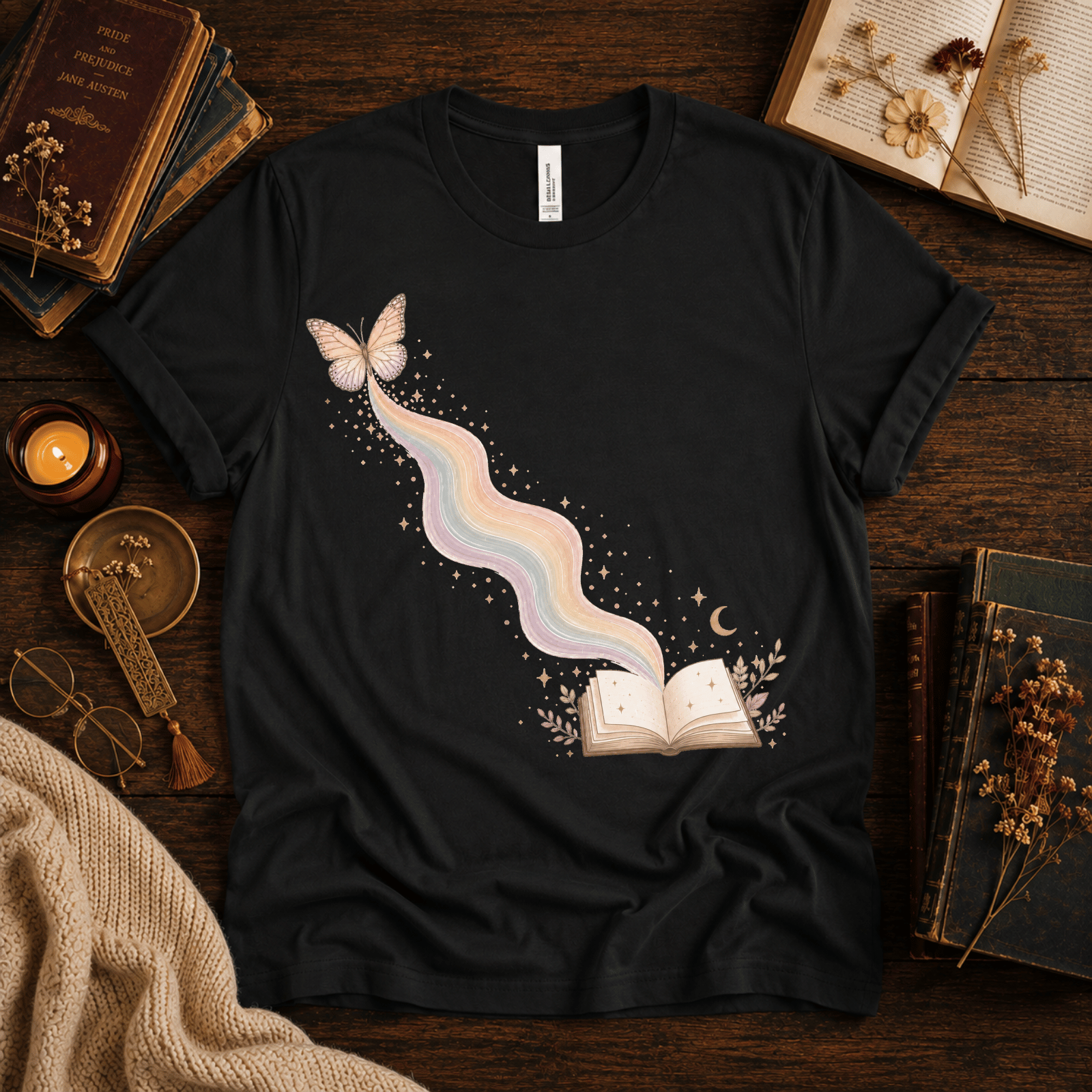 Rainbow Book whimsical book graphic t-shirt cozy flat lay in vintage black.