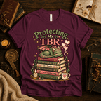 Protecting My TBR cute book graphic t-shirt cozy flat lay in maroon.