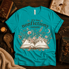 Nonfictiony whimsical book graphic t-shirt cozy flat lay in heather sea green.