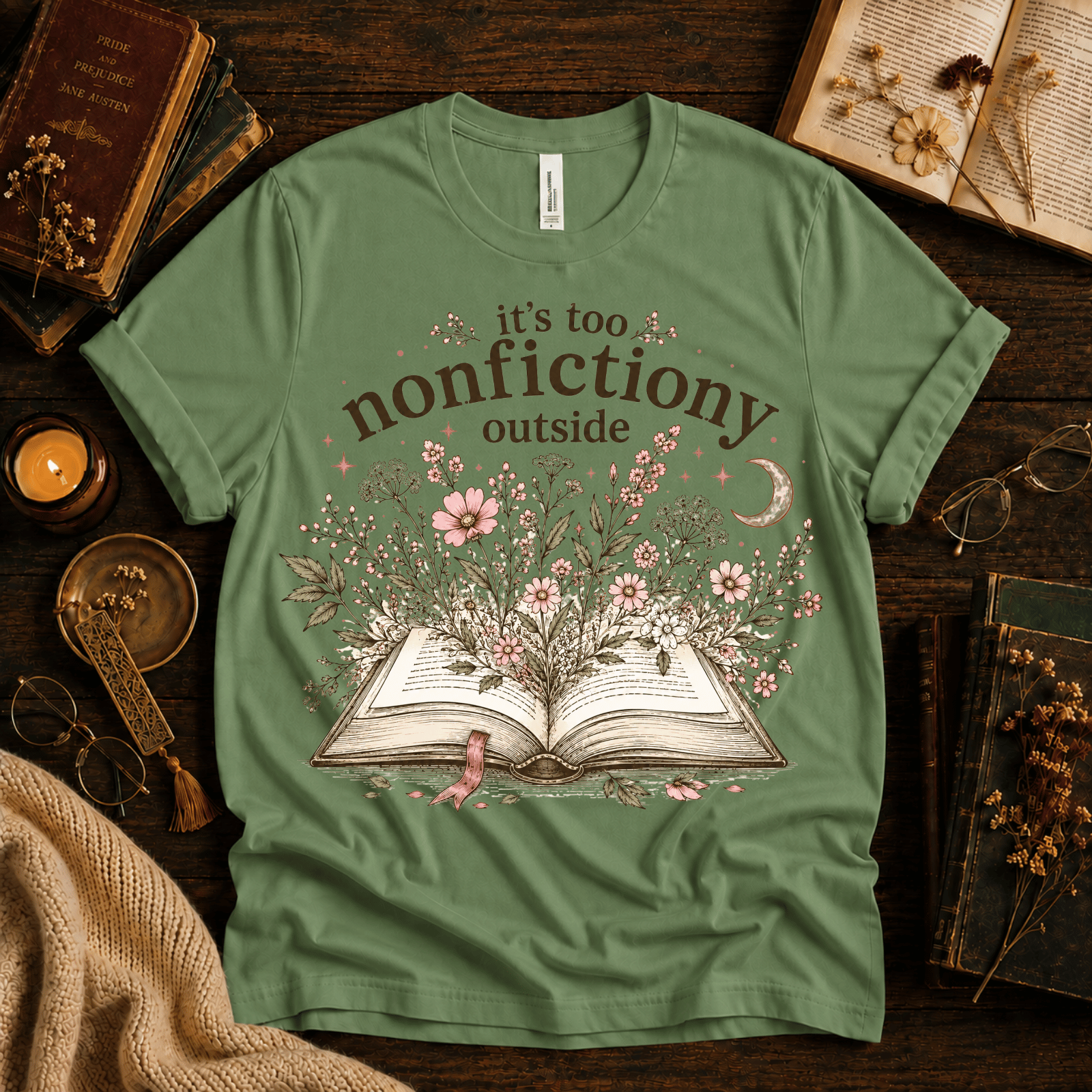 Nonfictiony whimsical book graphic t-shirt cozy flat lay in leaf.