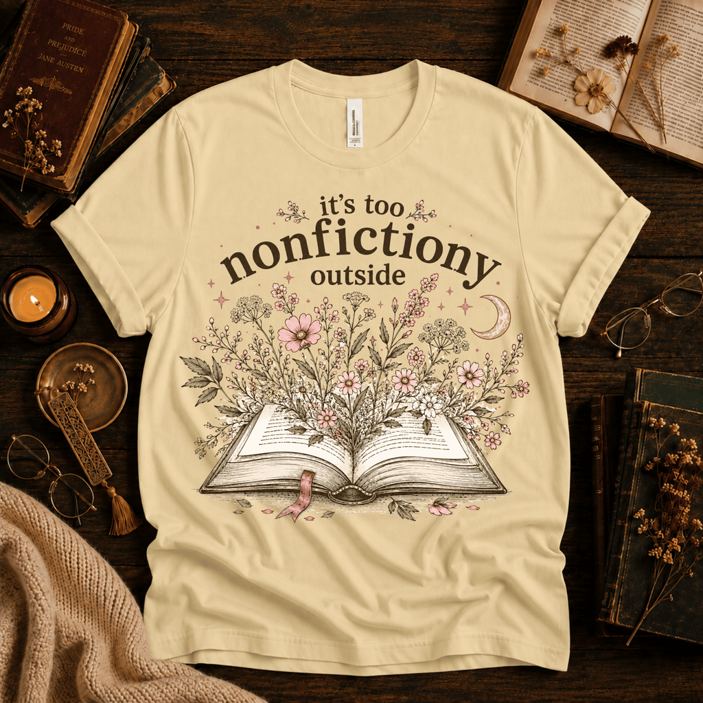 Nonfictiony whimsical book graphic t-shirt cozy flat lay in natural.