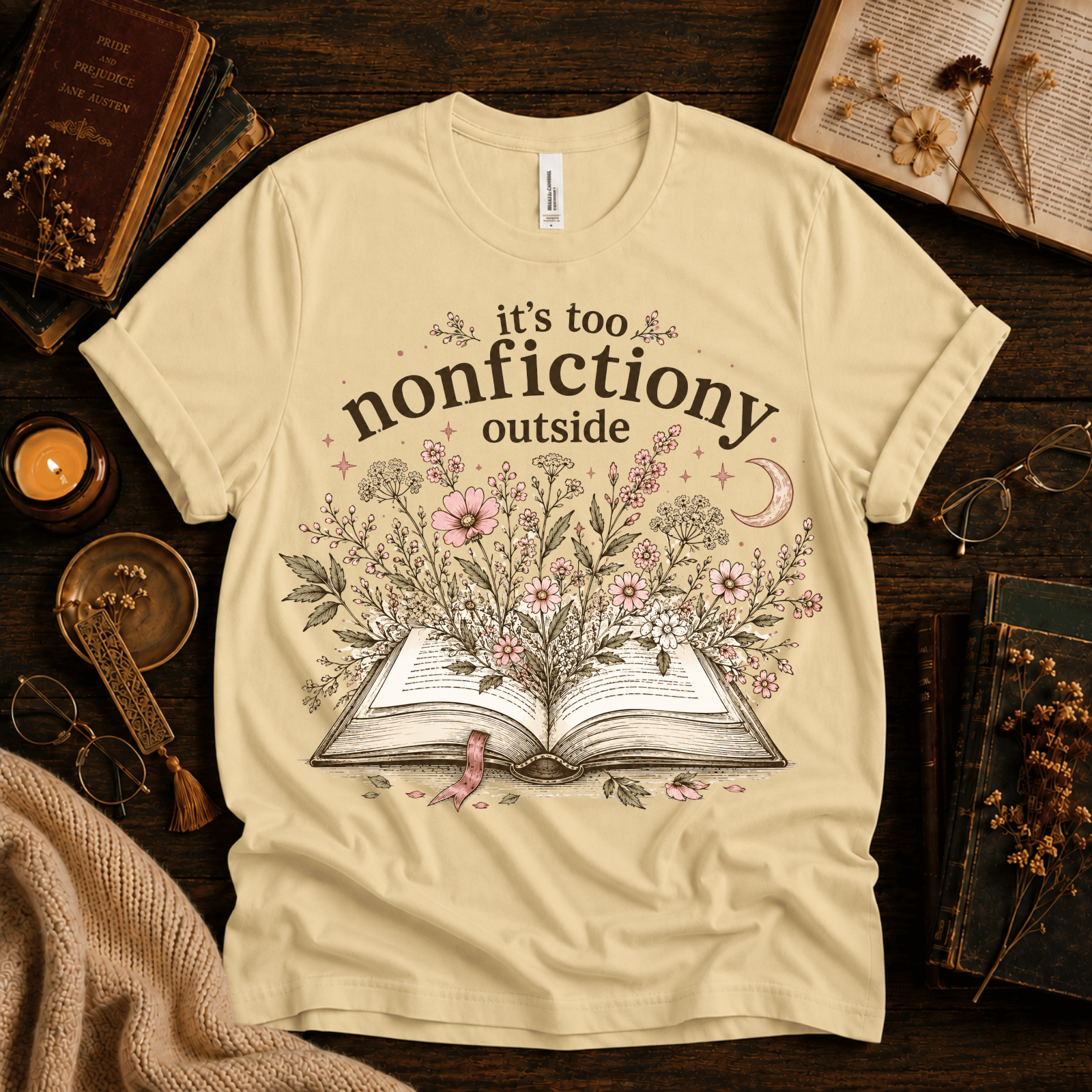 Nonfictiony whimsical book graphic t-shirt cozy flat lay in natural.