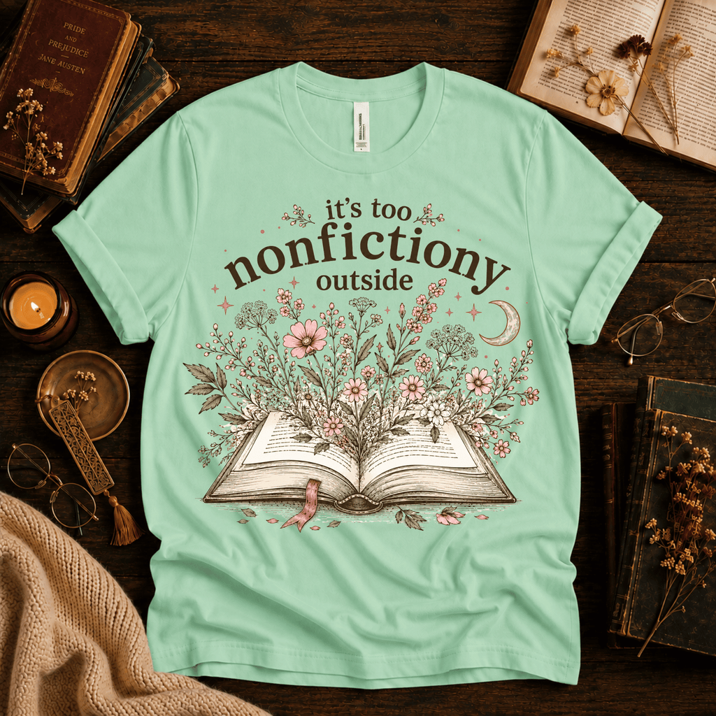 Nonfictiony whimsical book graphic t-shirt cozy flat lay in mint.