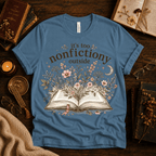 Nonfictiony whimsical book graphic t-shirt cozy flat lay in steel blue.