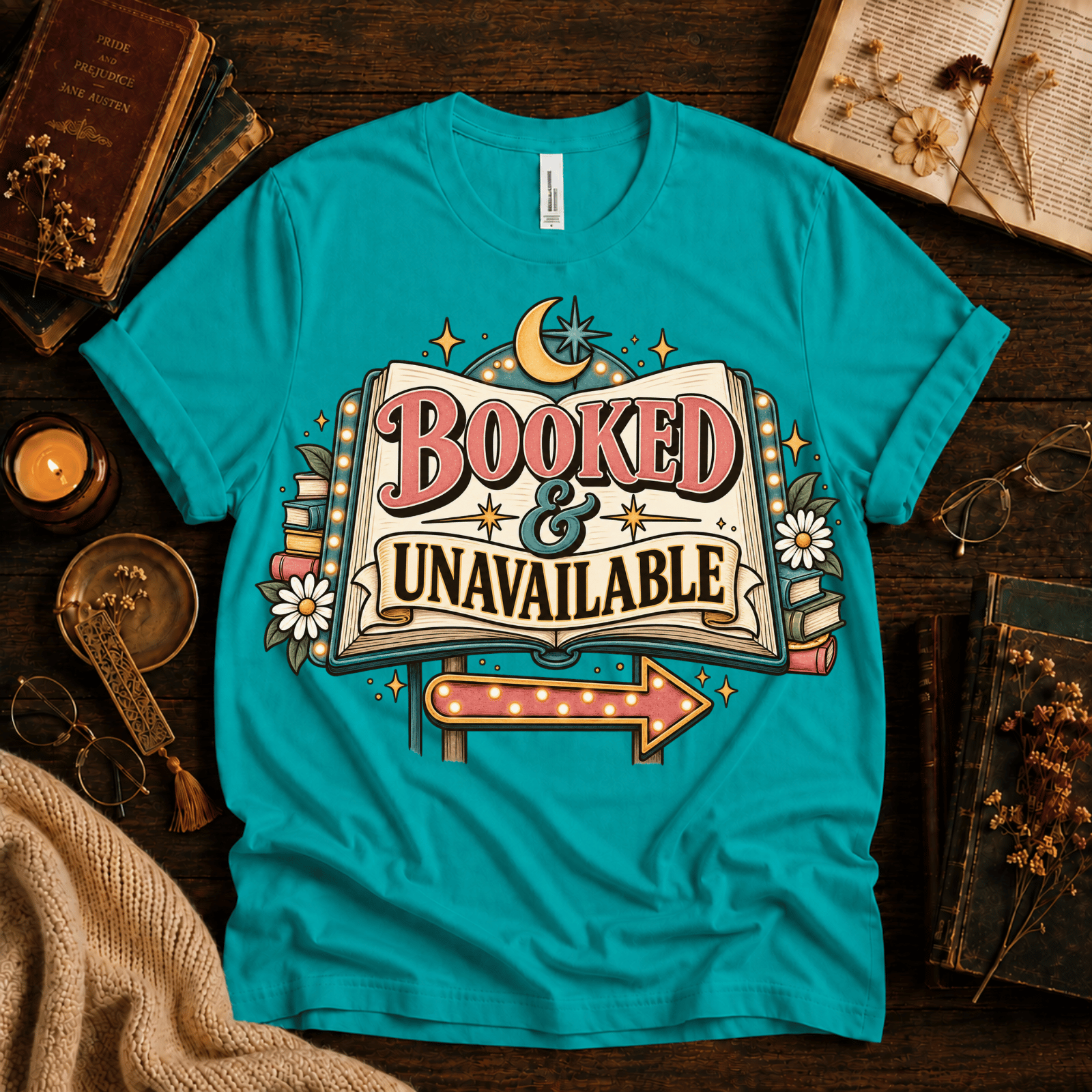 Booked & Unavailable cute book graphic t-shirt cozy flat lay in heather sea green.
