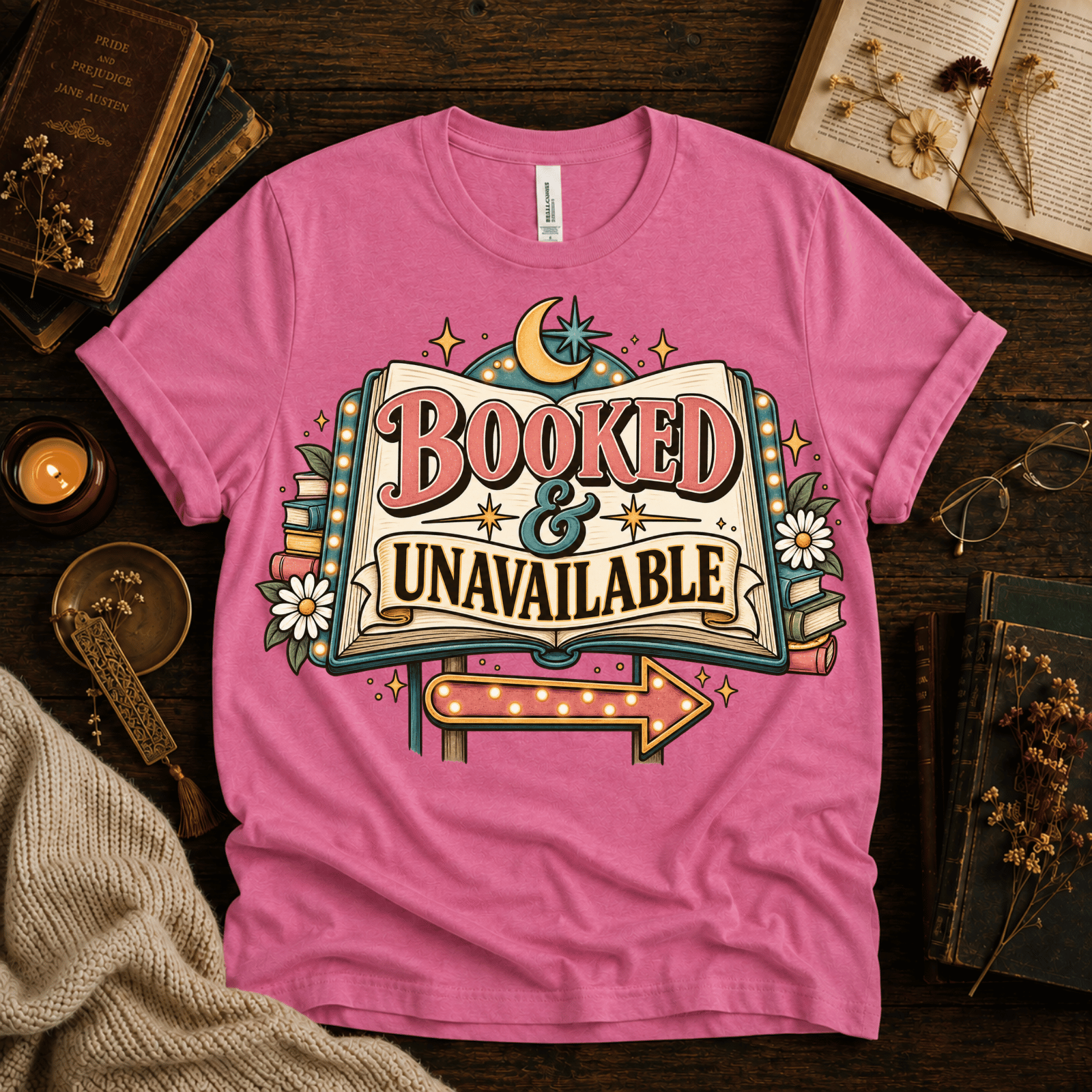 Booked & Unavailable cute book graphic t-shirt cozy flat lay in charity pink.