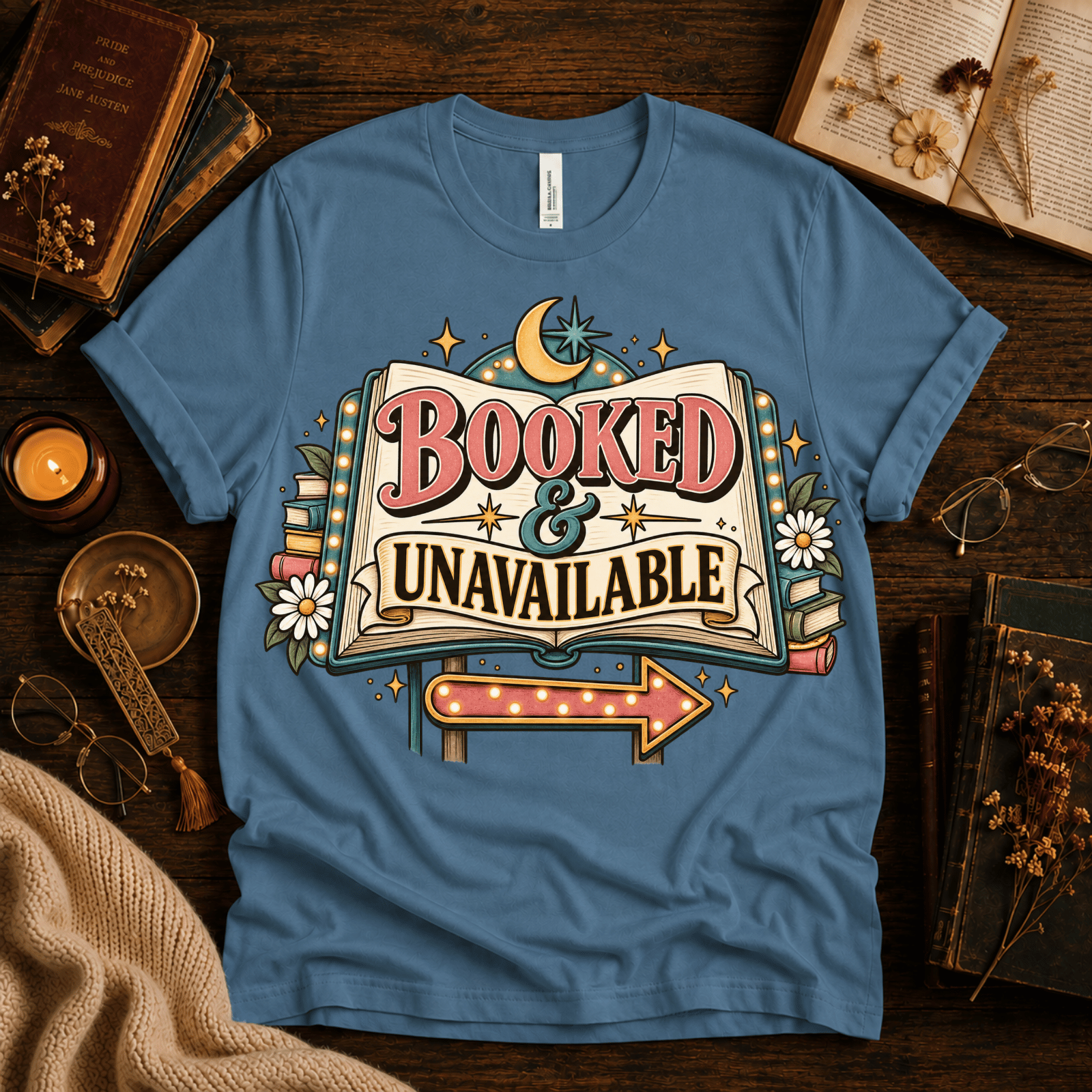 Booked & Unavailable cute book graphic t-shirt cozy flat lay in steel blue.