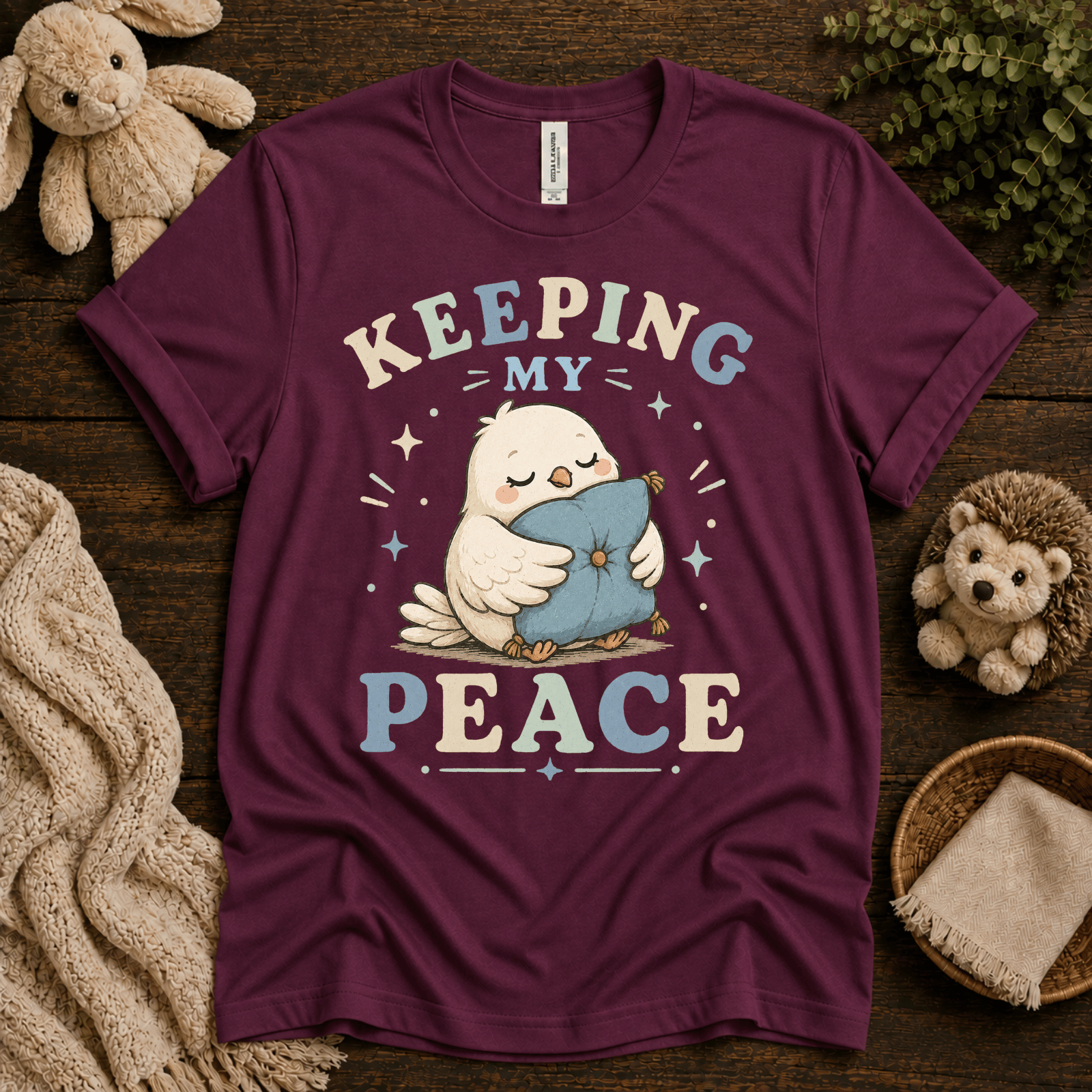 Keeping My Peace cute animal graphic t-shirt cozy flat lay in maroon.