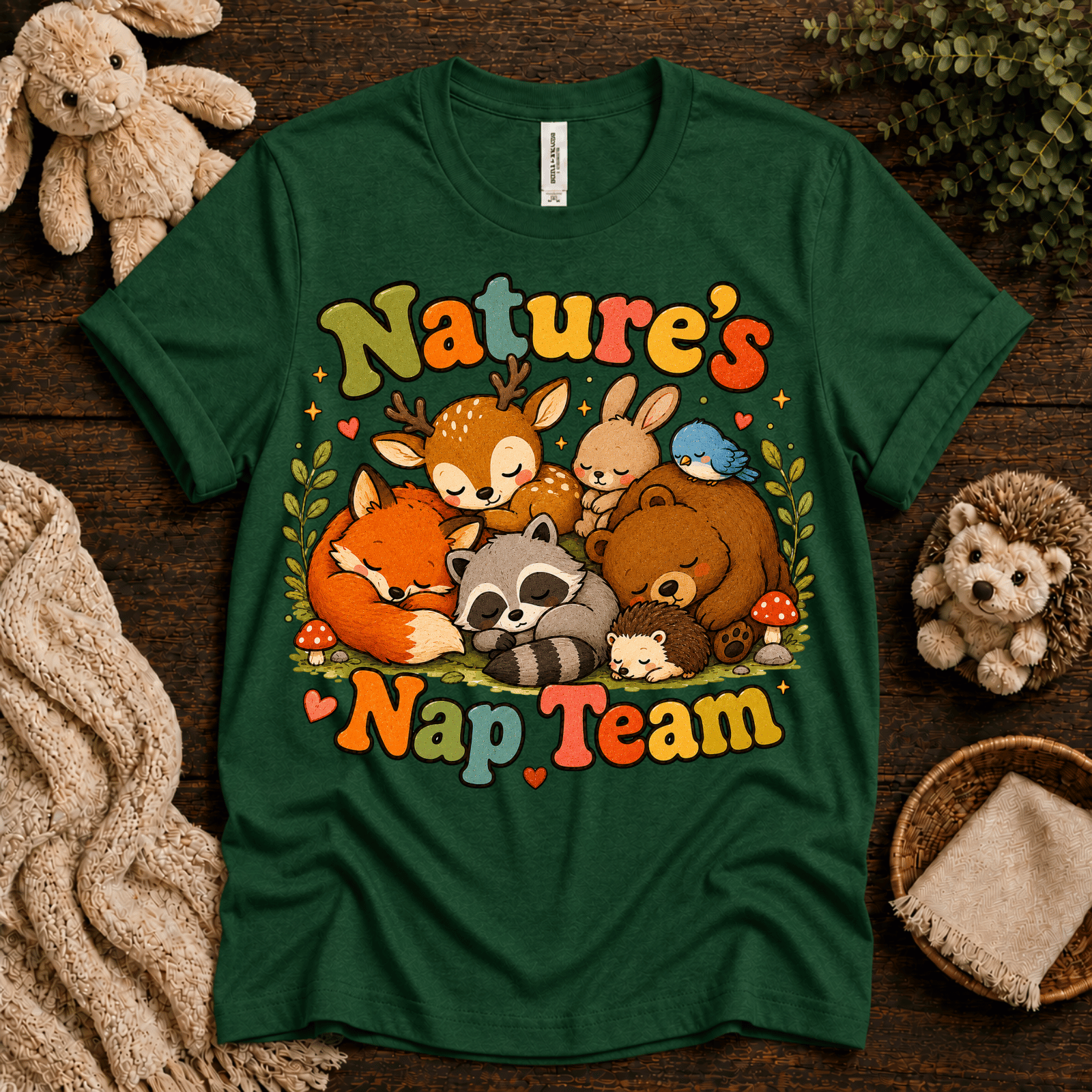 Nature's Nap Team cute animal graphic t-shirt cozy flat lay in evergreen.