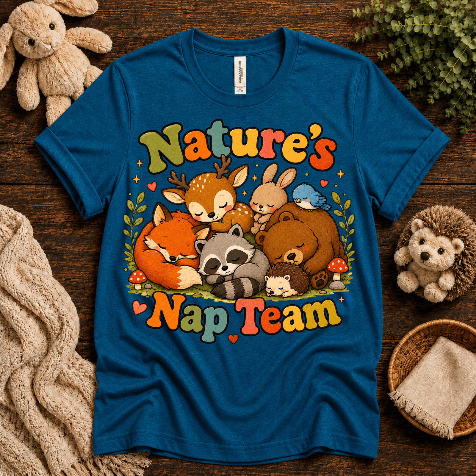 Nature's Nap Team cute animal graphic t-shirt cozy flat lay in deep teal.