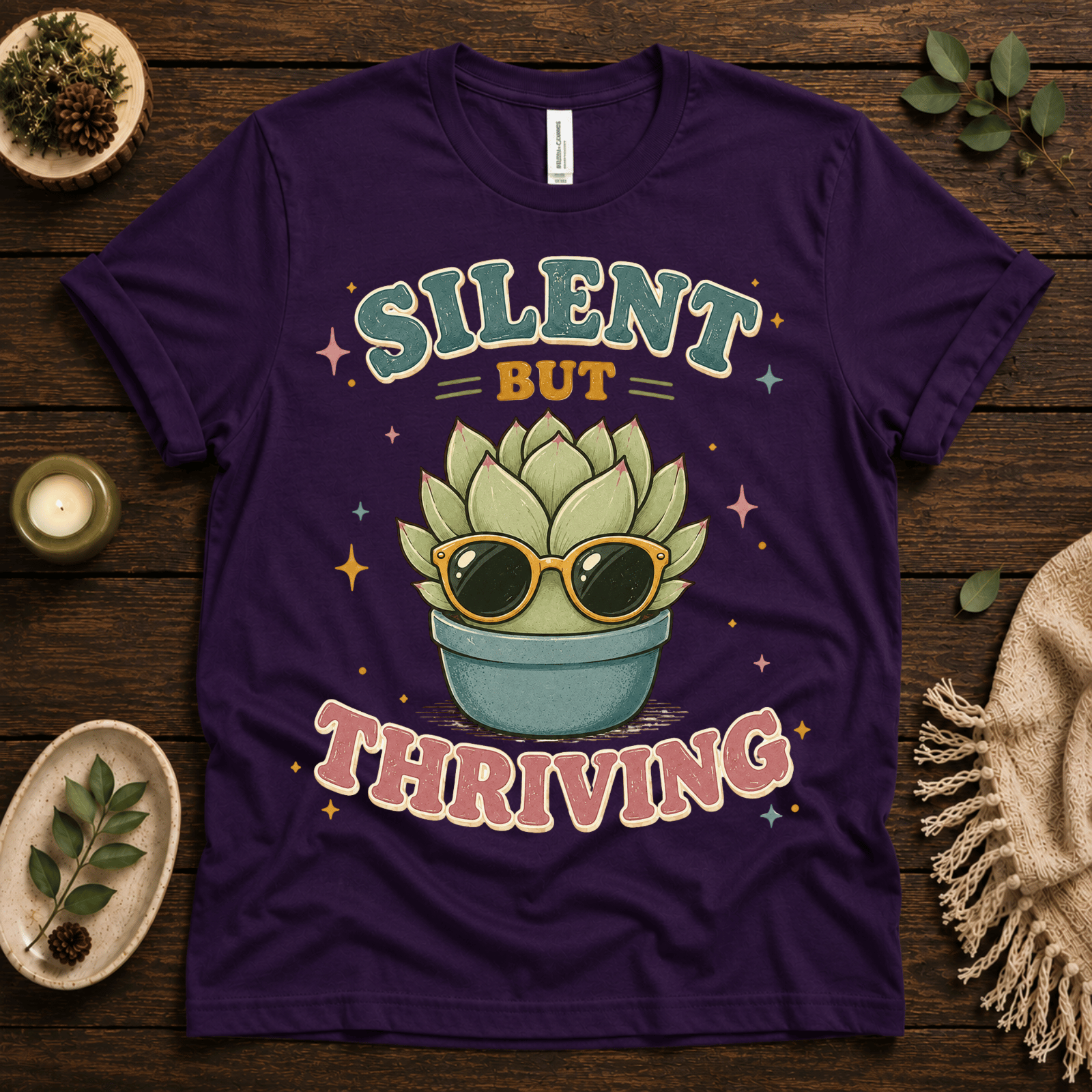 Silent But Thriving funny plant graphic t-shirt cozy flat lay in team purple.