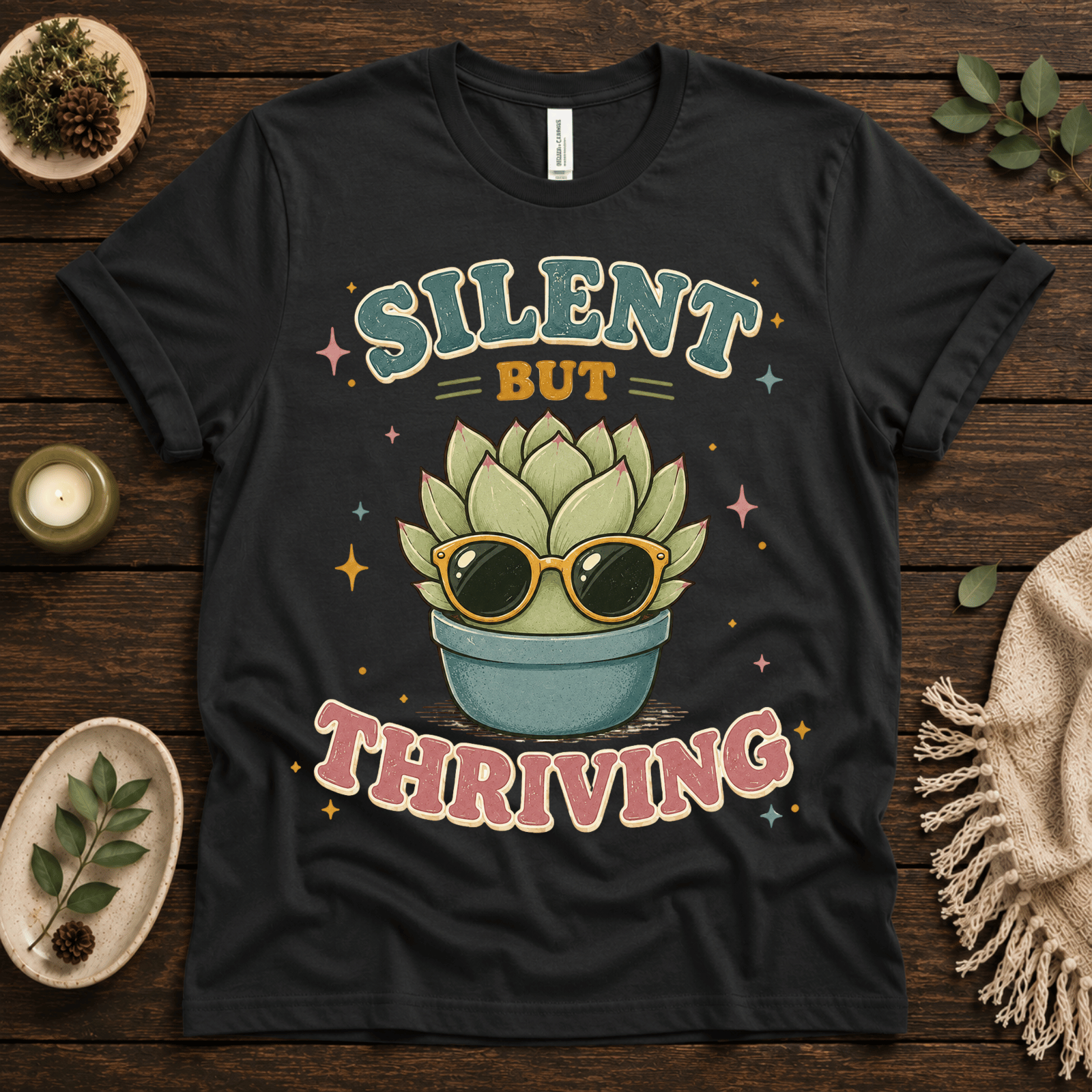 Silent But Thriving funny plant graphic t-shirt cozy flat lay in vintage black.