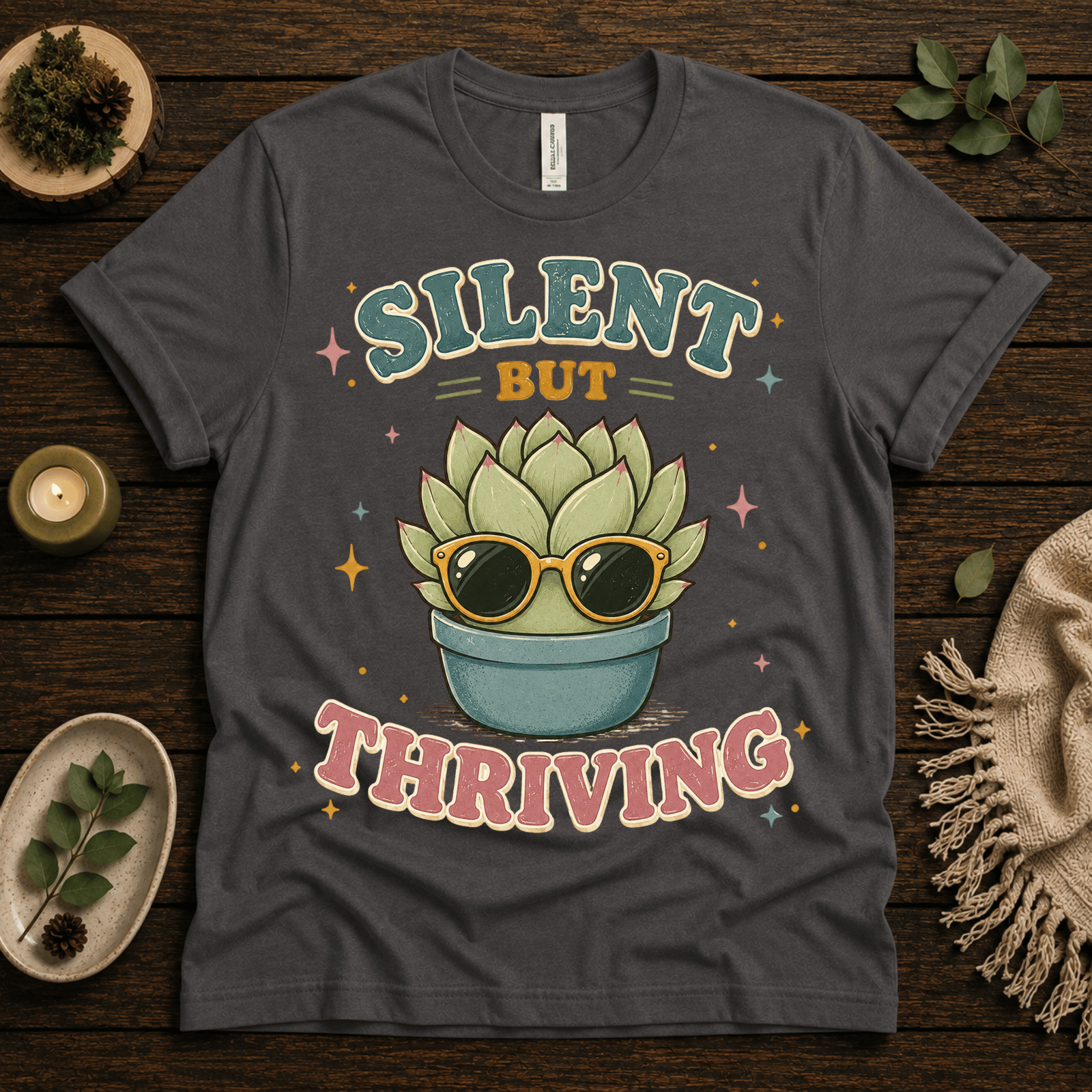 Silent But Thriving funny plant graphic t-shirt cozy flat lay in asphalt.