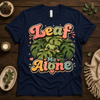 Leaf Me Alone funny nature graphic t-shirt cozy flat lay in navy.