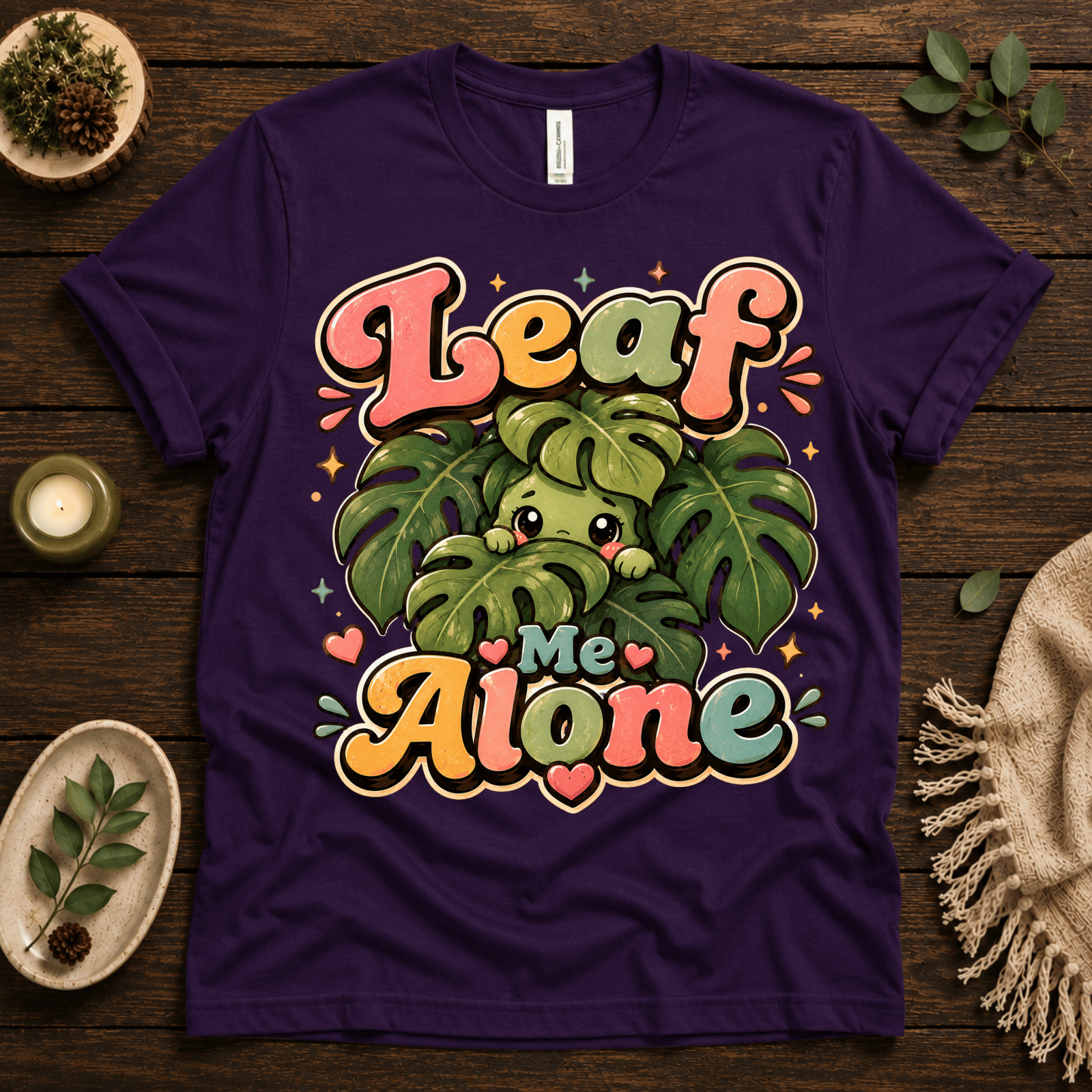 Leaf Me Alone funny nature graphic t-shirt cozy flat lay in team purple.