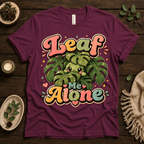 Leaf Me Alone funny nature graphic t-shirt cozy flat lay in maroon.