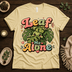 Leaf Me Alone funny nature graphic t-shirt cozy flat lay in natural.