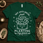 Planting My Peace cute plant graphic t-shirt cozy flat lay in evergreen.