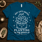 Planting My Peace cute plant graphic t-shirt cozy flat lay in deep teal.