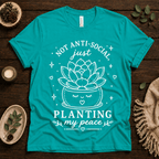 Planting My Peace cute plant graphic t-shirt cozy flat lay in heather sea green.