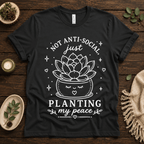 Planting My Peace cute plant graphic t-shirt cozy flat lay in vintage black.