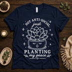 Planting My Peace cute plant graphic t-shirt cozy flat lay in navy.
