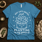 Planting My Peace cute plant graphic t-shirt cozy flat lay in aqua.