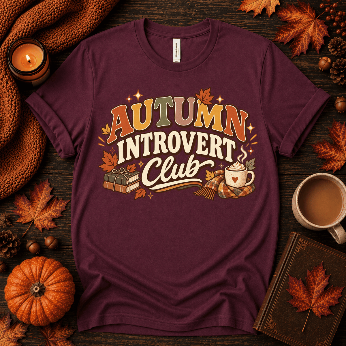 Autumn Introvert Club cute fall graphic t-shirt cozy flat lay in maroon.