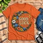 Good Luck In Gold cute celestial graphic t-shirt cozy flat lay in burnt orange.