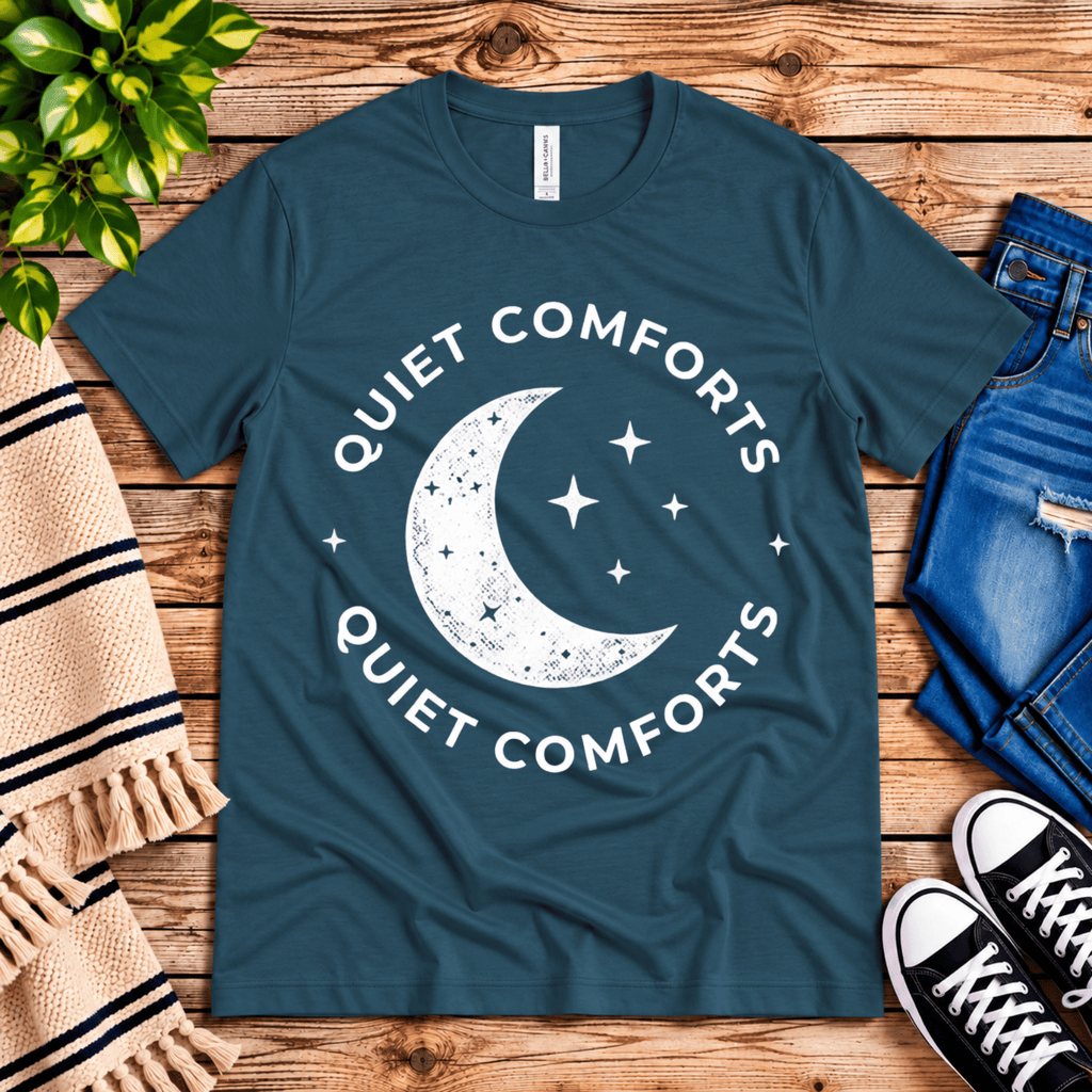 Quiet Comforts celestial graphic t-shirt cozy flat lay in deep teal.