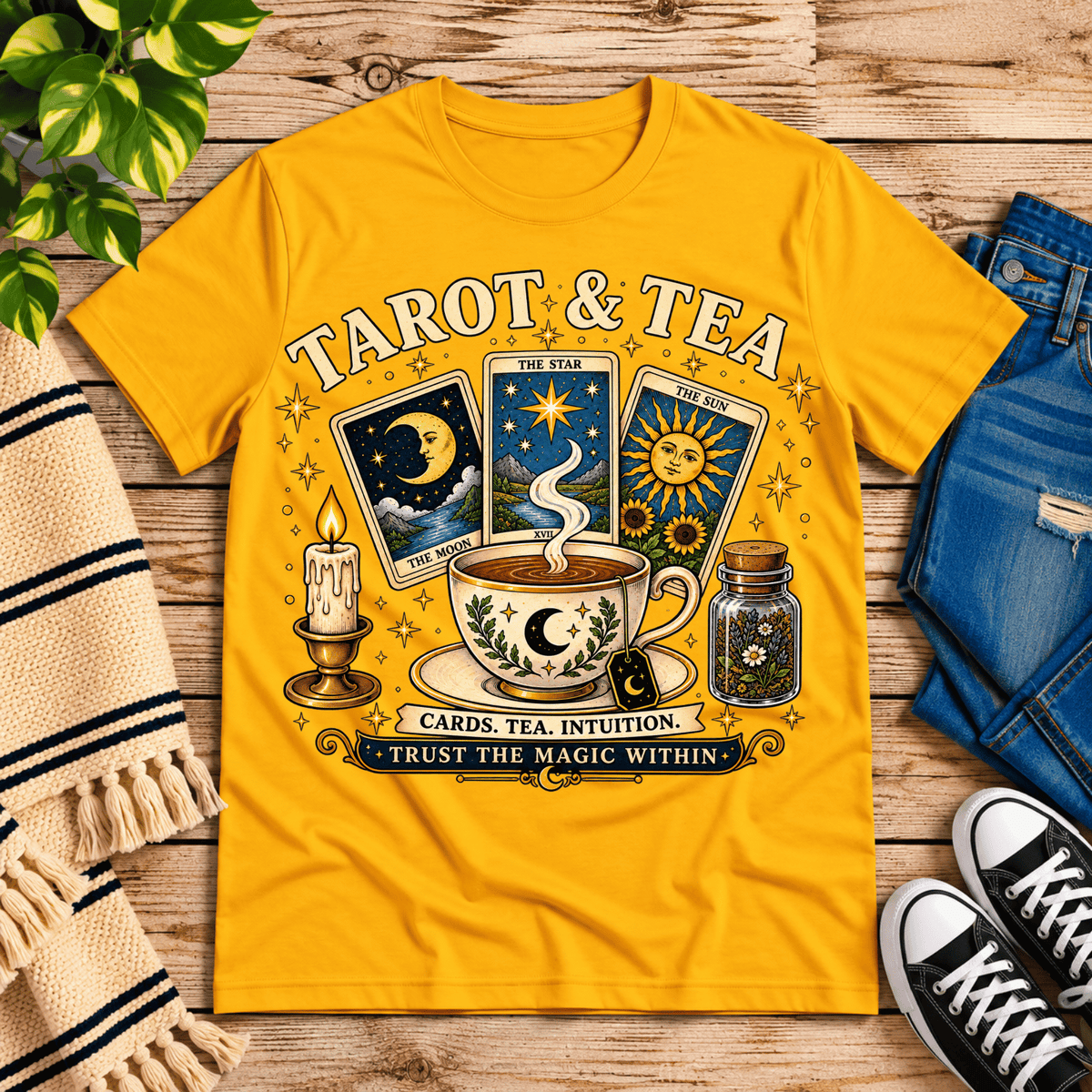 Tarot & Tea tarot card graphic t-shirt cozy flat lay in gold.