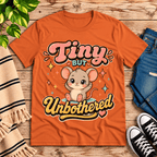 Tiny But Unbothered cute animal graphic t-shirt cozy flat lay in burnt orange.