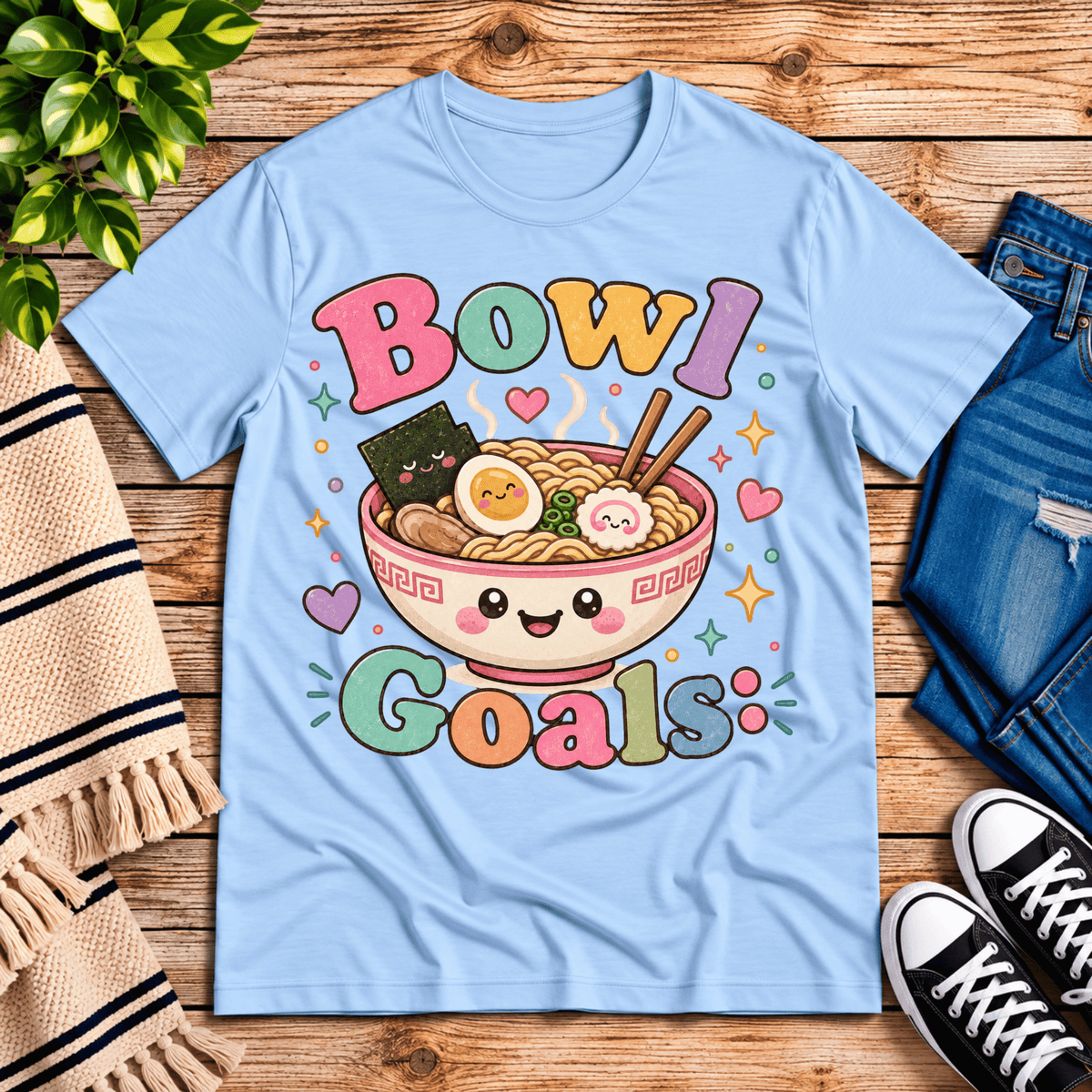Bowl Goals cute food graphic t-shirt cozy flat lay in baby blue.