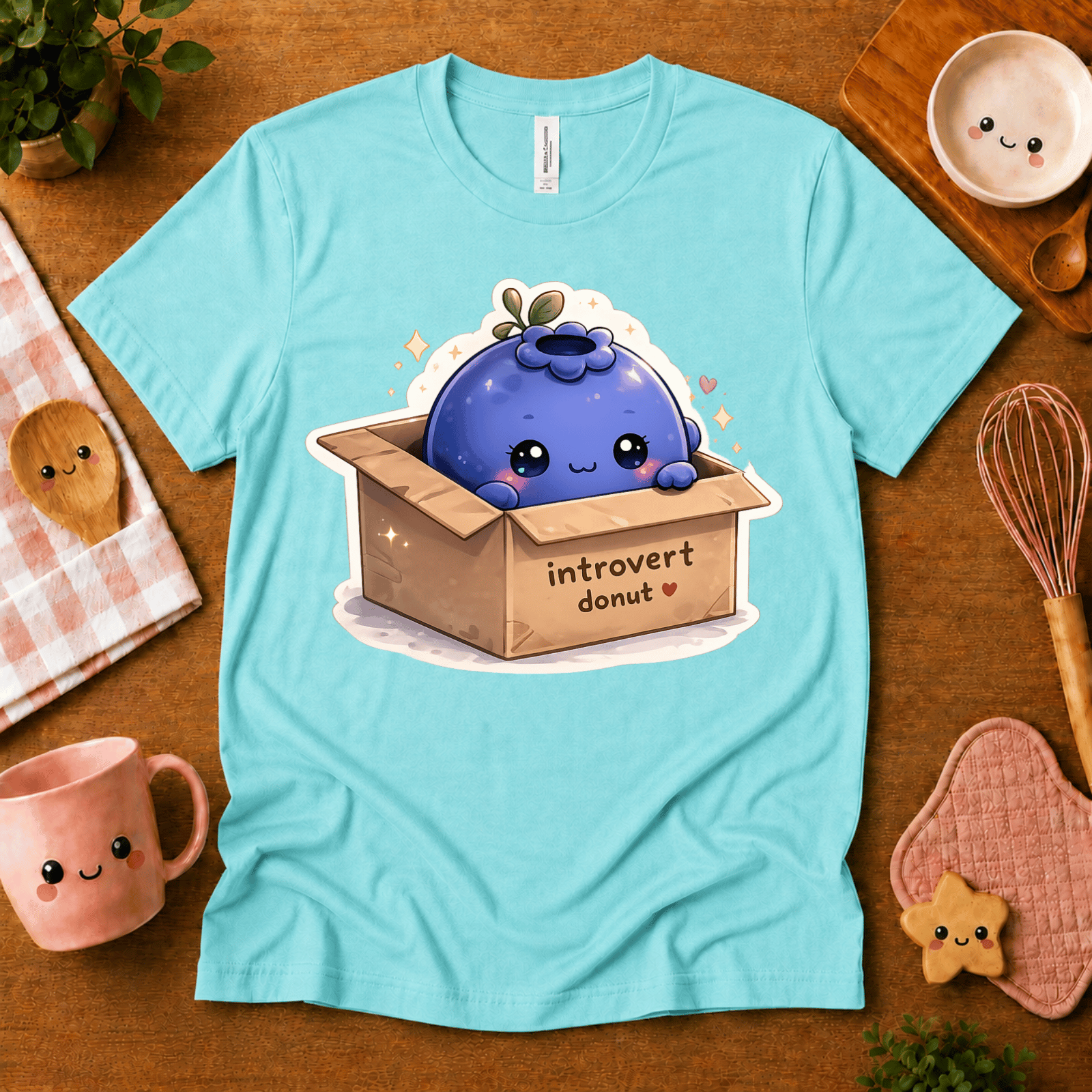 Blueberry Box cute food graphic t-shirt in cozy flat lay in aqua.