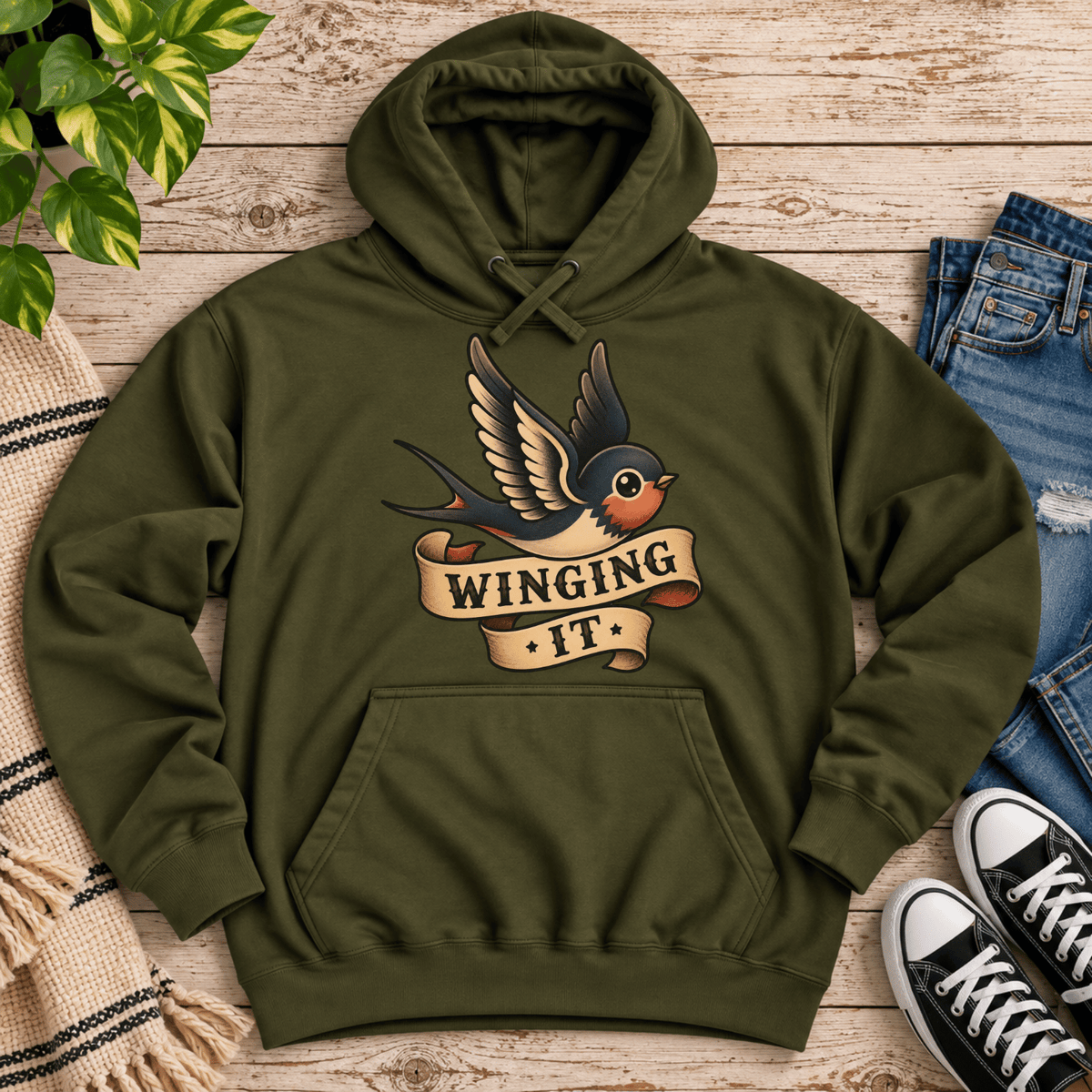 Winging It cute animal graphic hoodie cozy flat lay in army green.